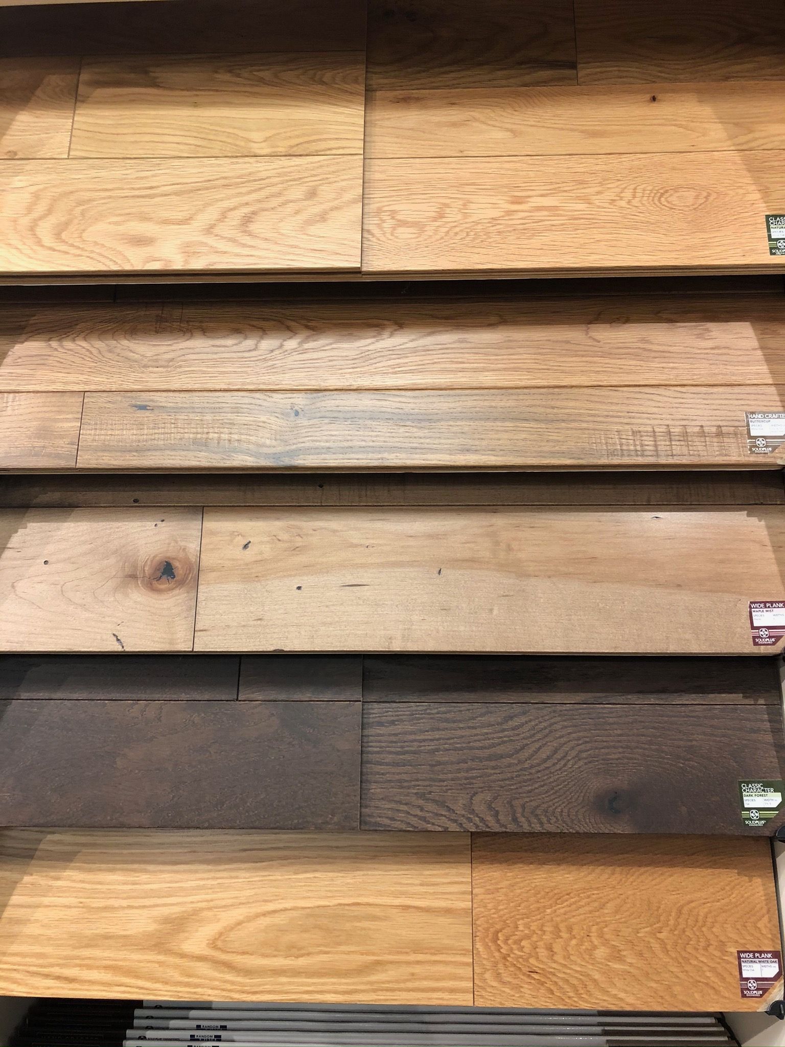 A shelf filled with different types of wooden flooring.