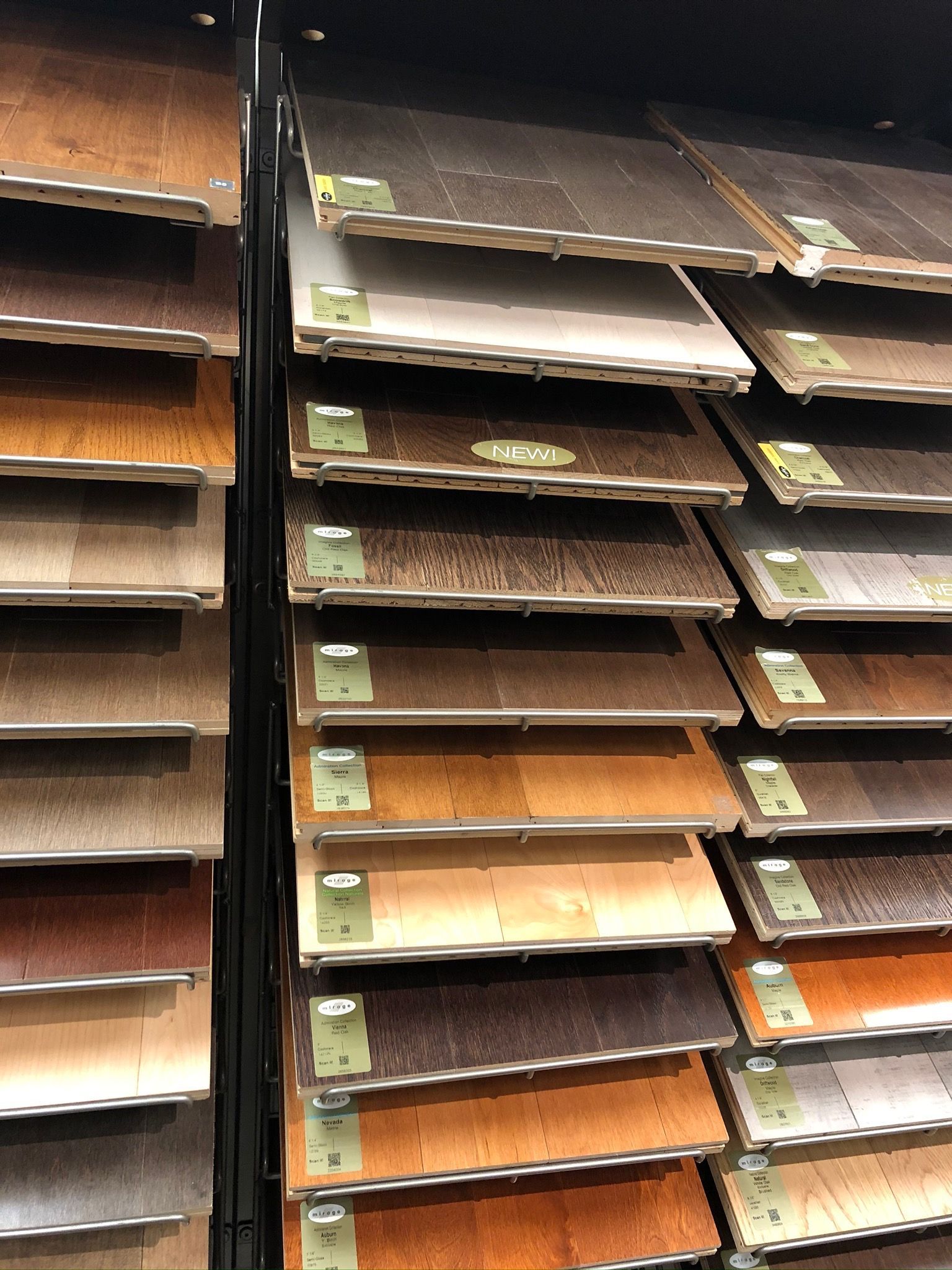 A display of different types of hardwood flooring in a store.
