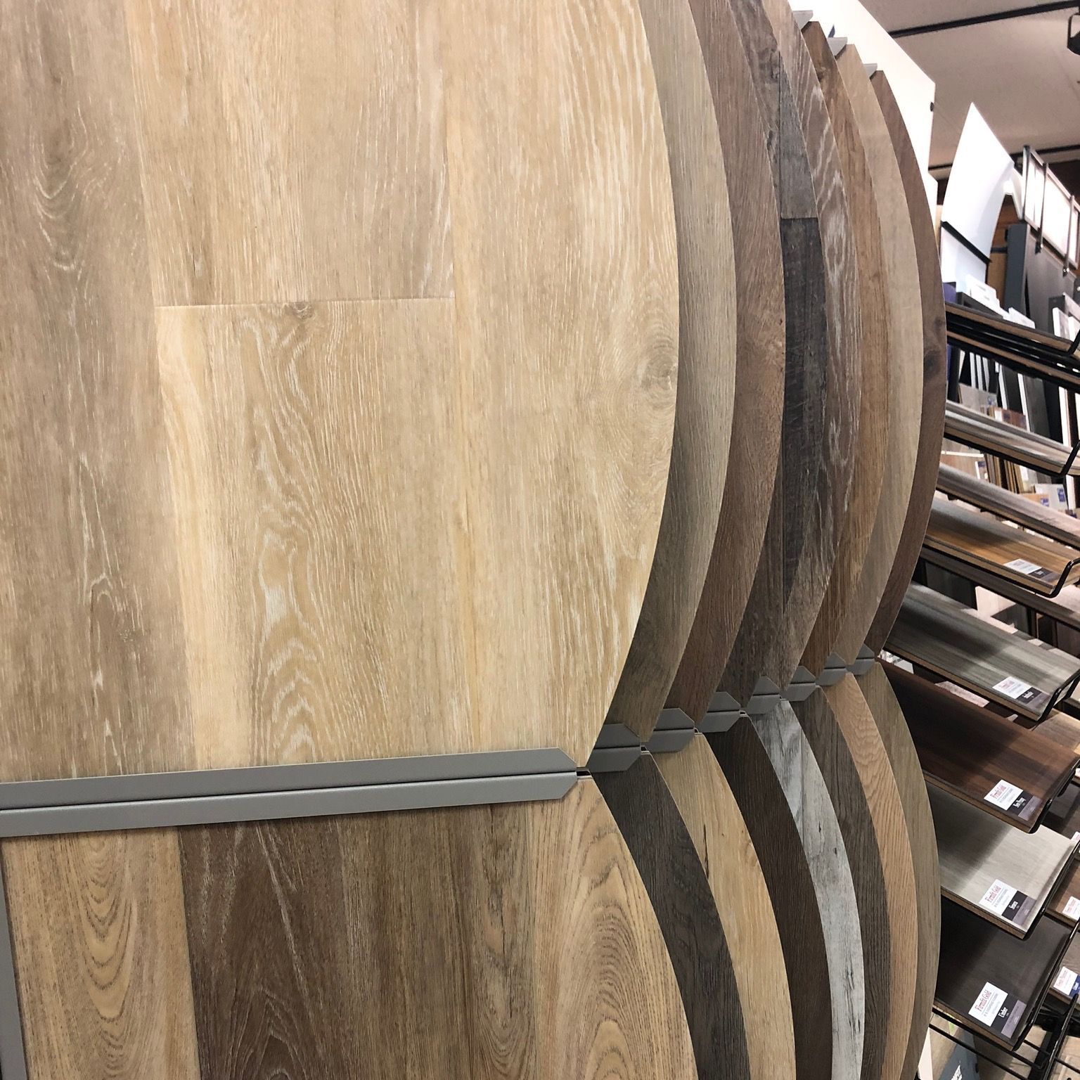 A row of wooden barrels are stacked on top of each other in a store.
