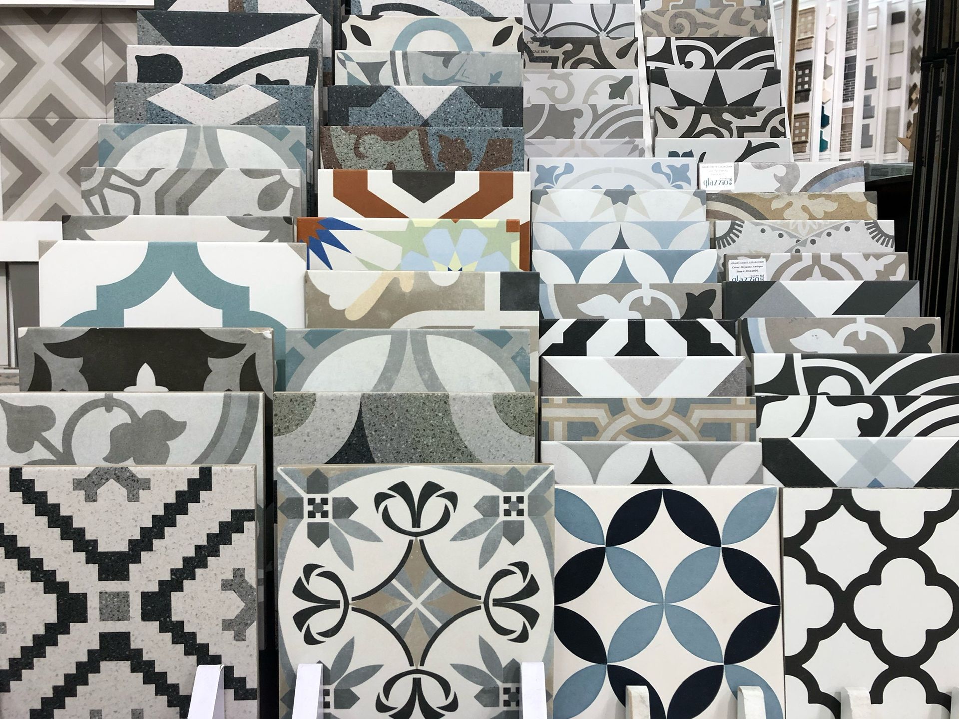 A bunch of tiles with different designs are stacked on top of each other.