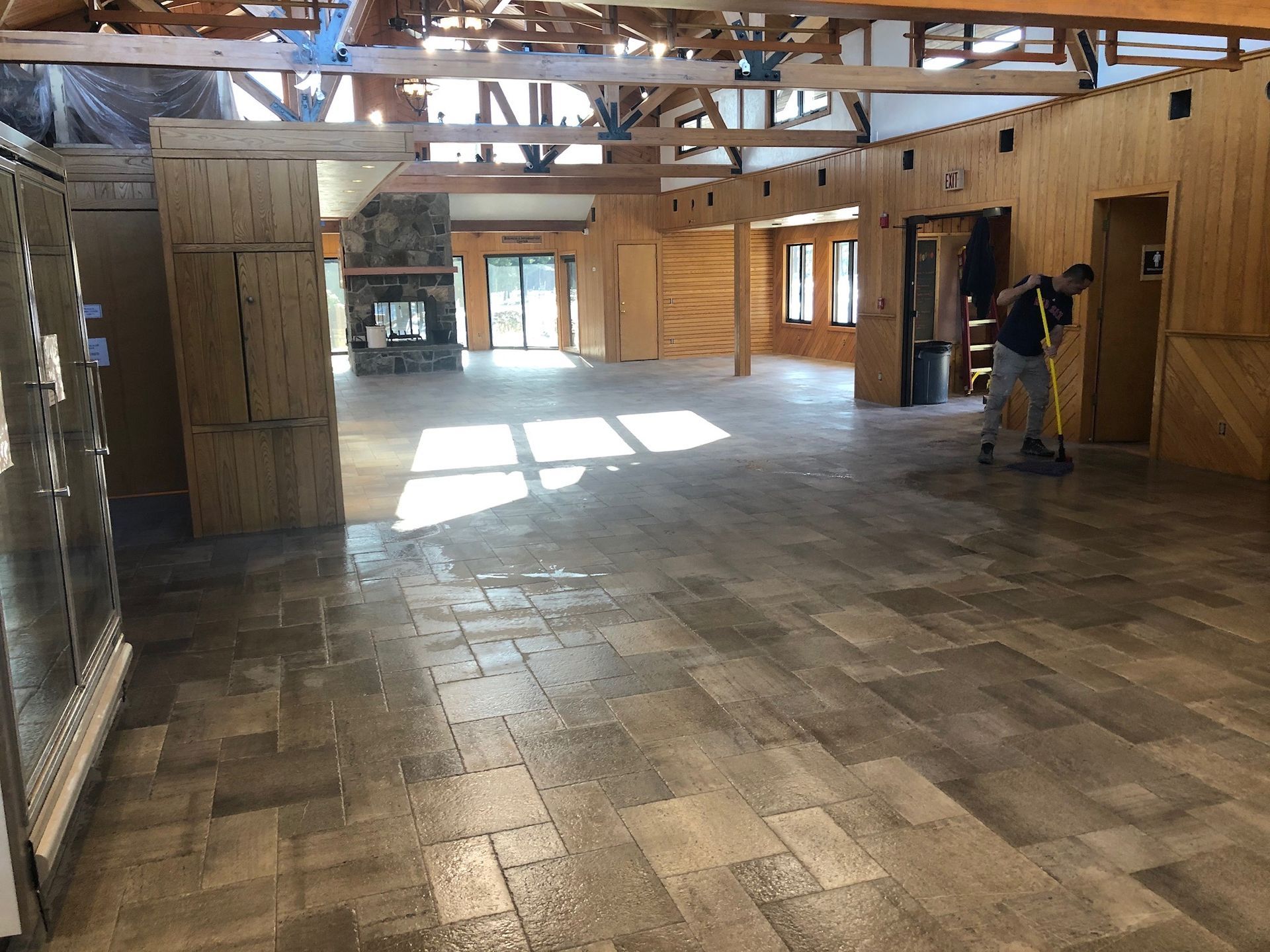 A large room with a tiled floor and wooden walls