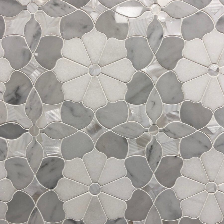 A close up of a marble tile with flowers on it