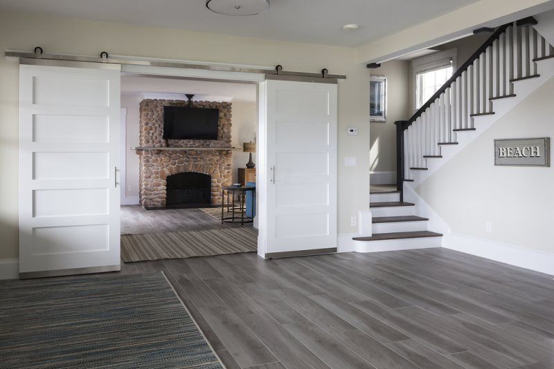 A living room with a staircase and a sign that says beach