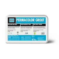 A box of permacolor grout is sitting on a white surface.