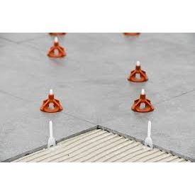 A row of tile spacers sitting on top of a tile floor.