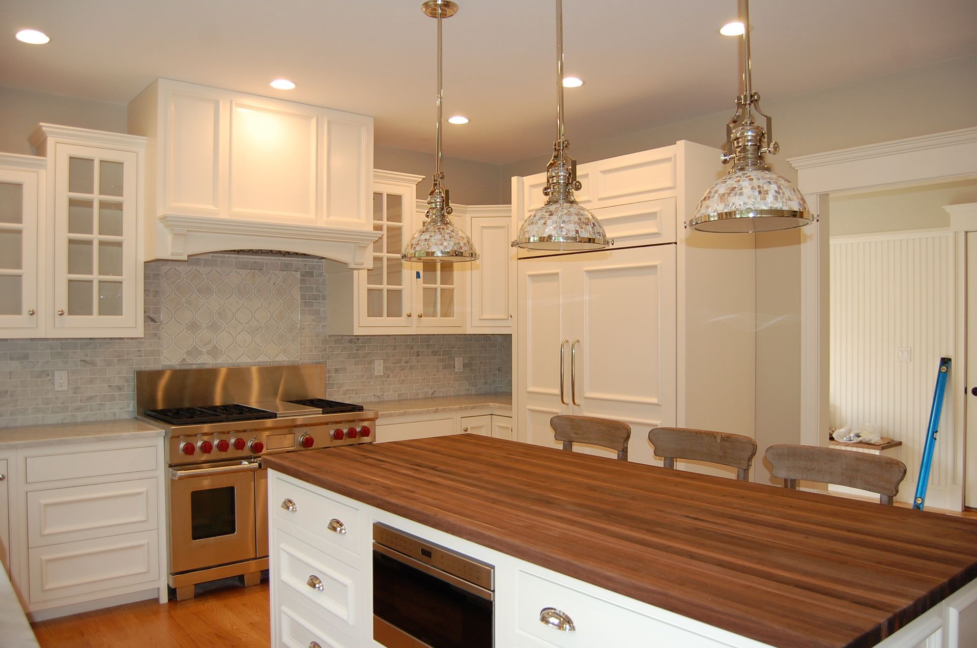 A kitchen with white cabinets and stainless steel appliances