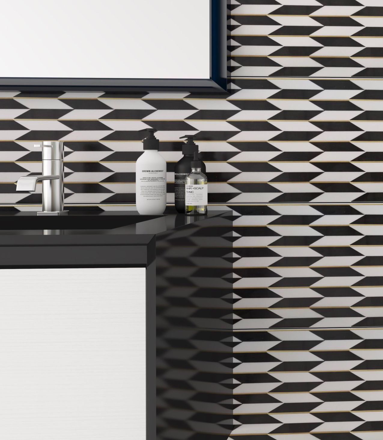 A bathroom with a black and white tile wall and a sink.