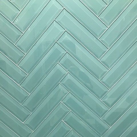 A close up of a herringbone pattern on a wall.