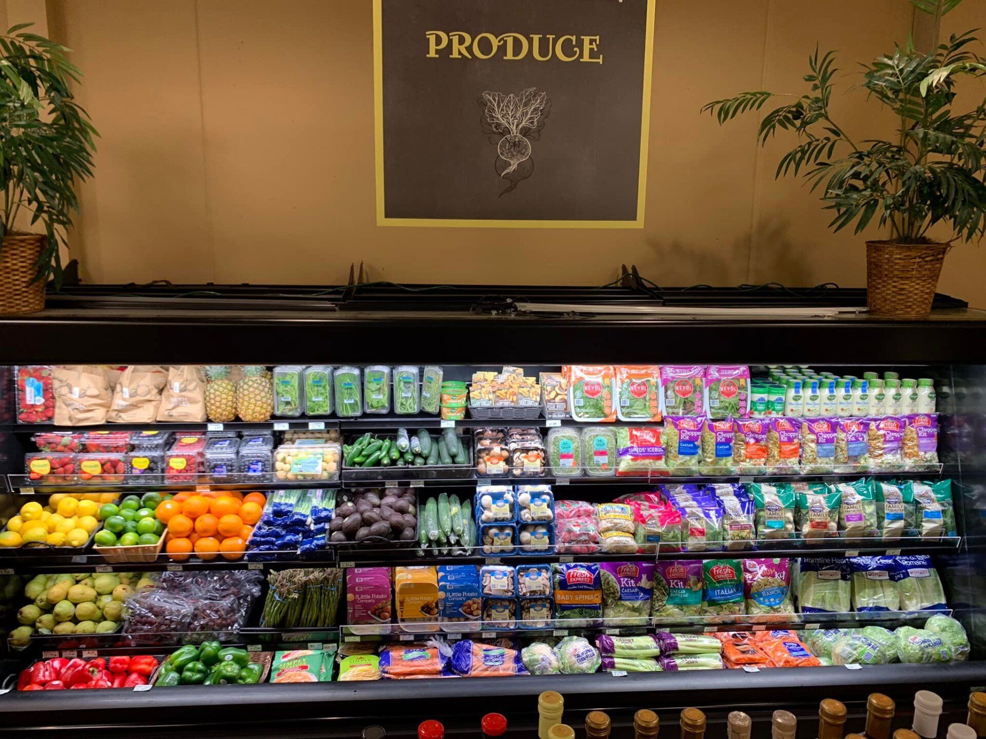 A produce section of a grocery store with a sign above it