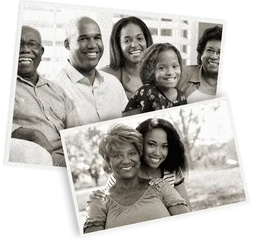 Couple looking at photo album, seated on a sofa.