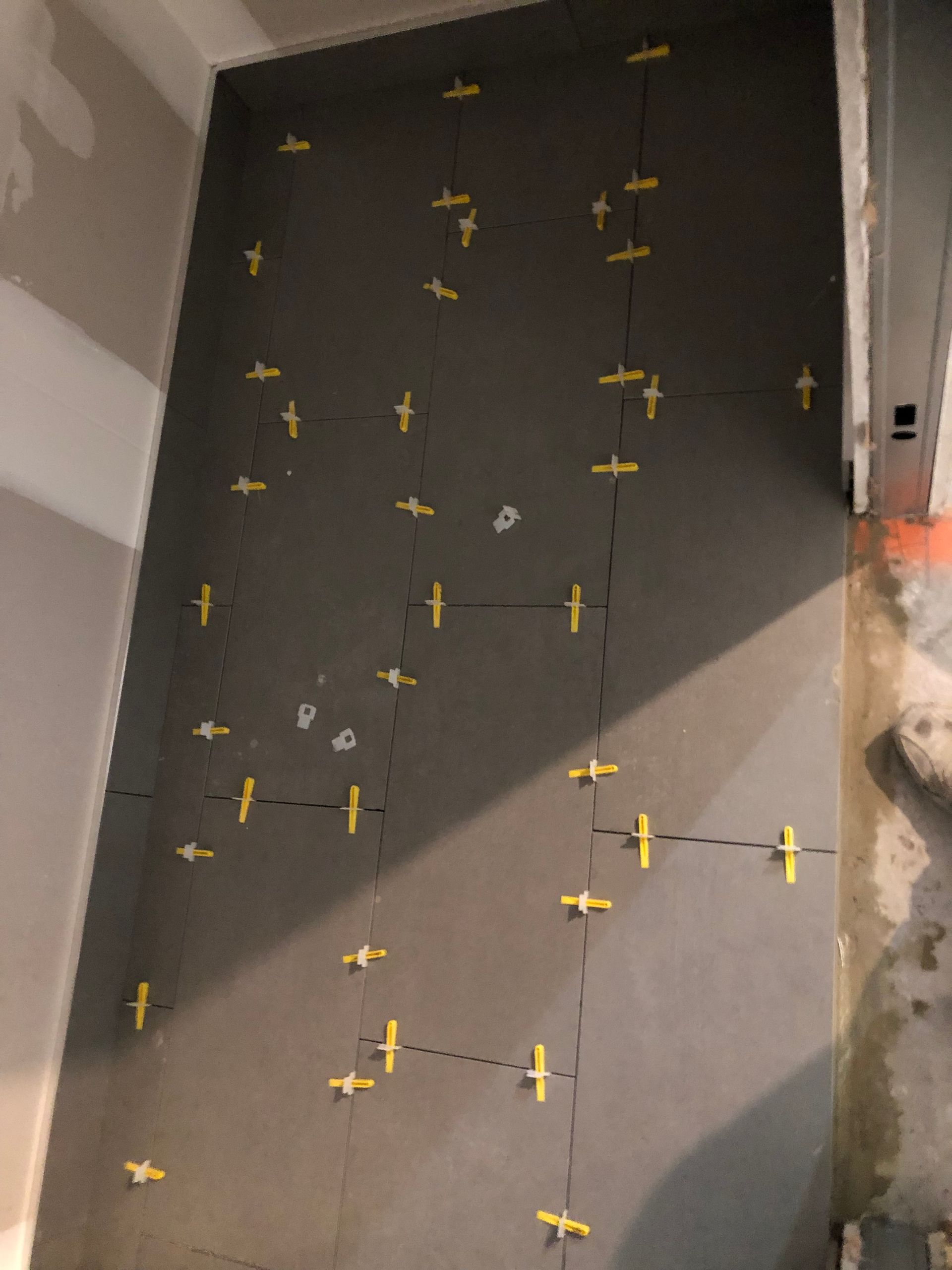 A wall with a lot of yellow crosses on it