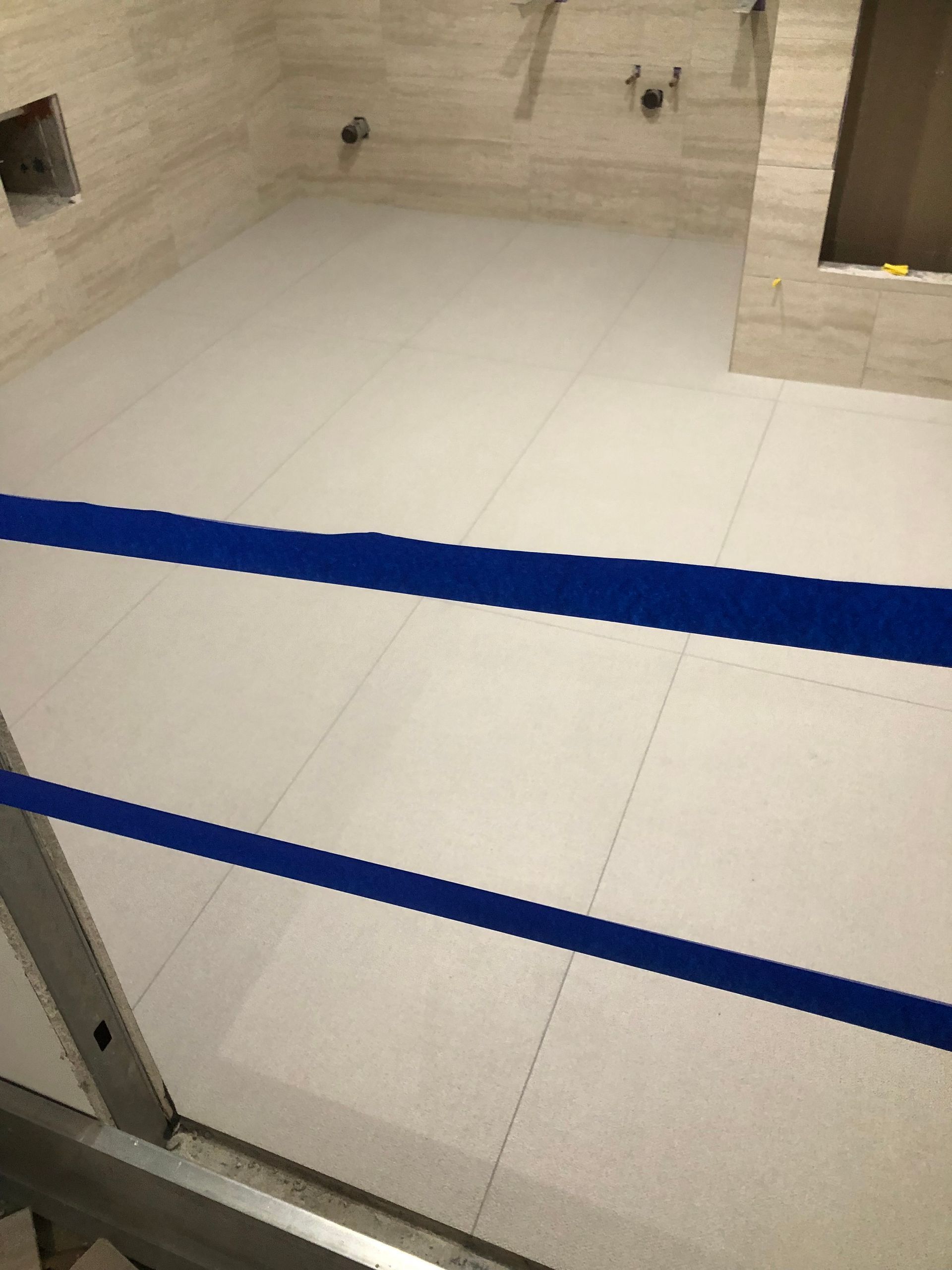 A boxing ring with a blue stripe on the floor