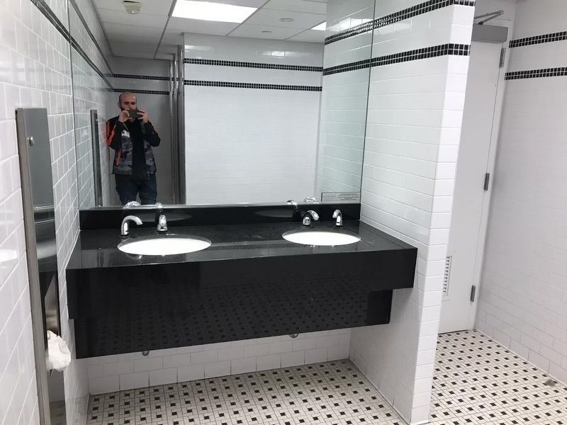 A man is taking a picture of himself in a bathroom mirror