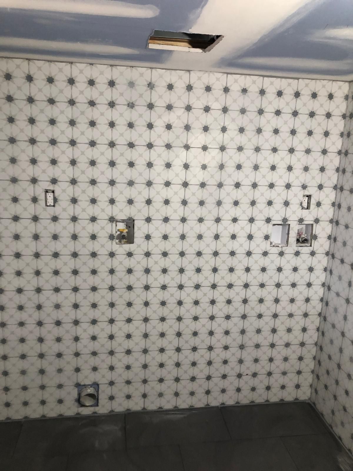 A bathroom with white tiles and a blue ceiling