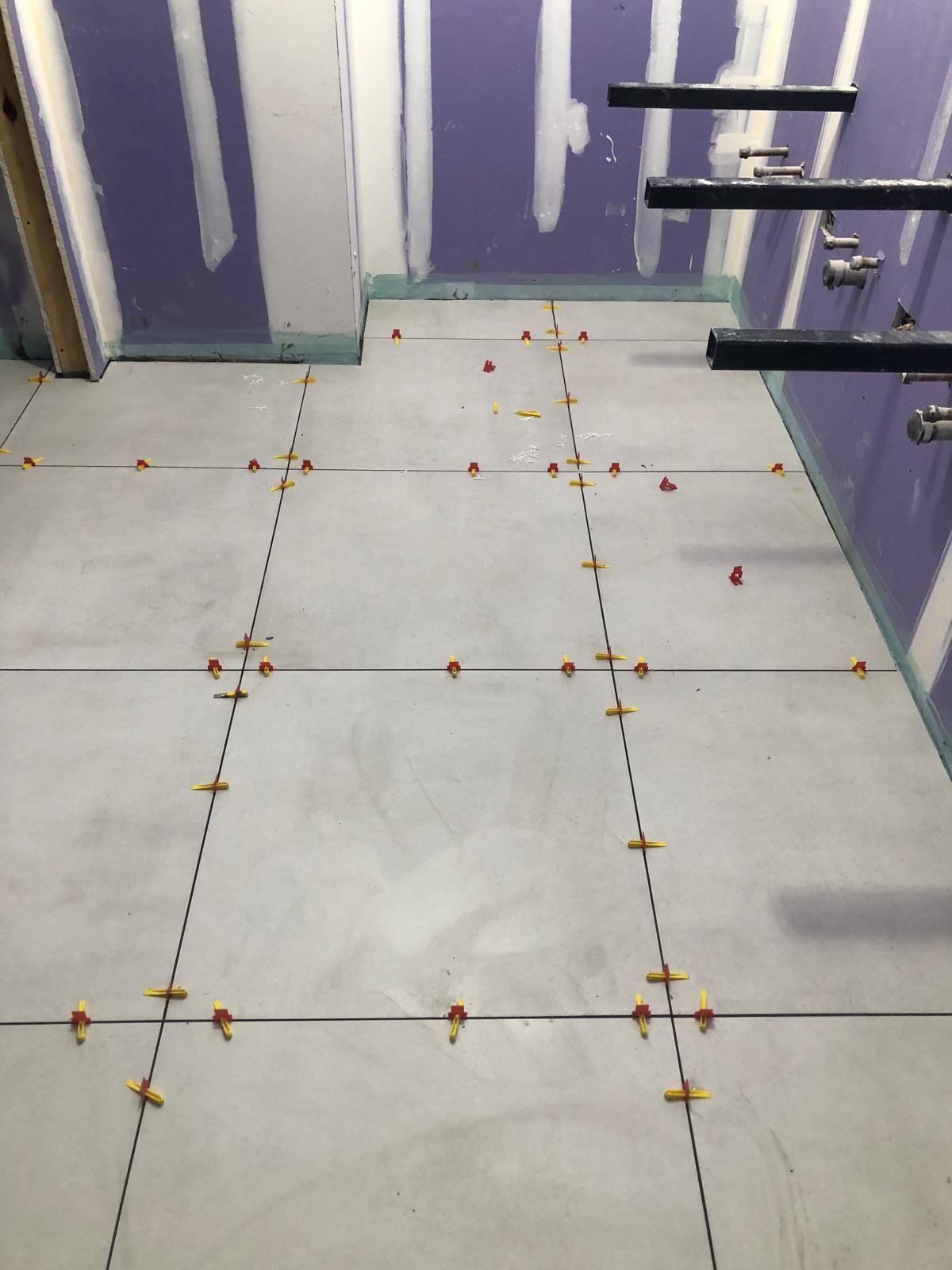 A tiled floor in a room with purple walls.