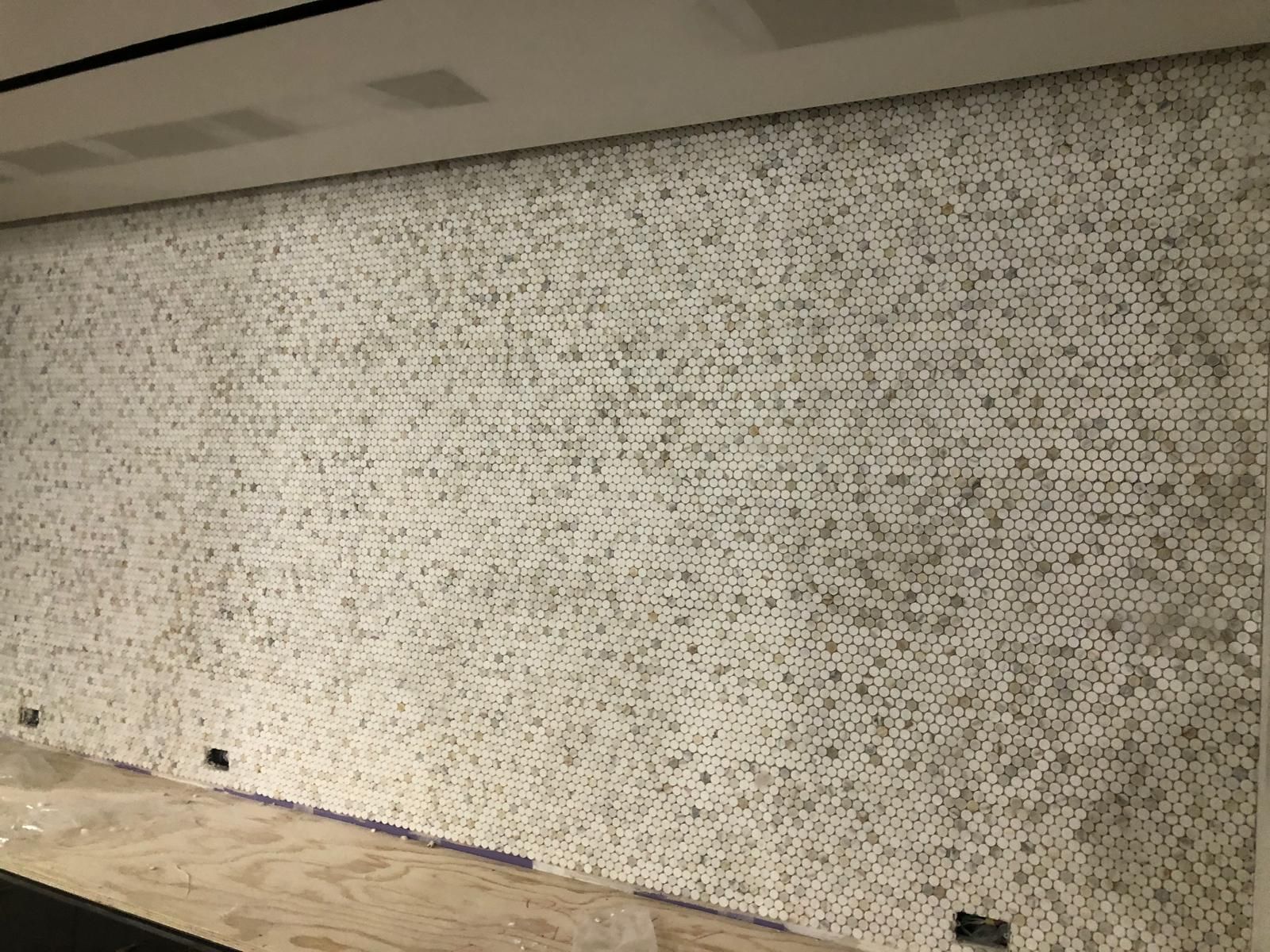 There is a large wall with a lot of tiles on it.