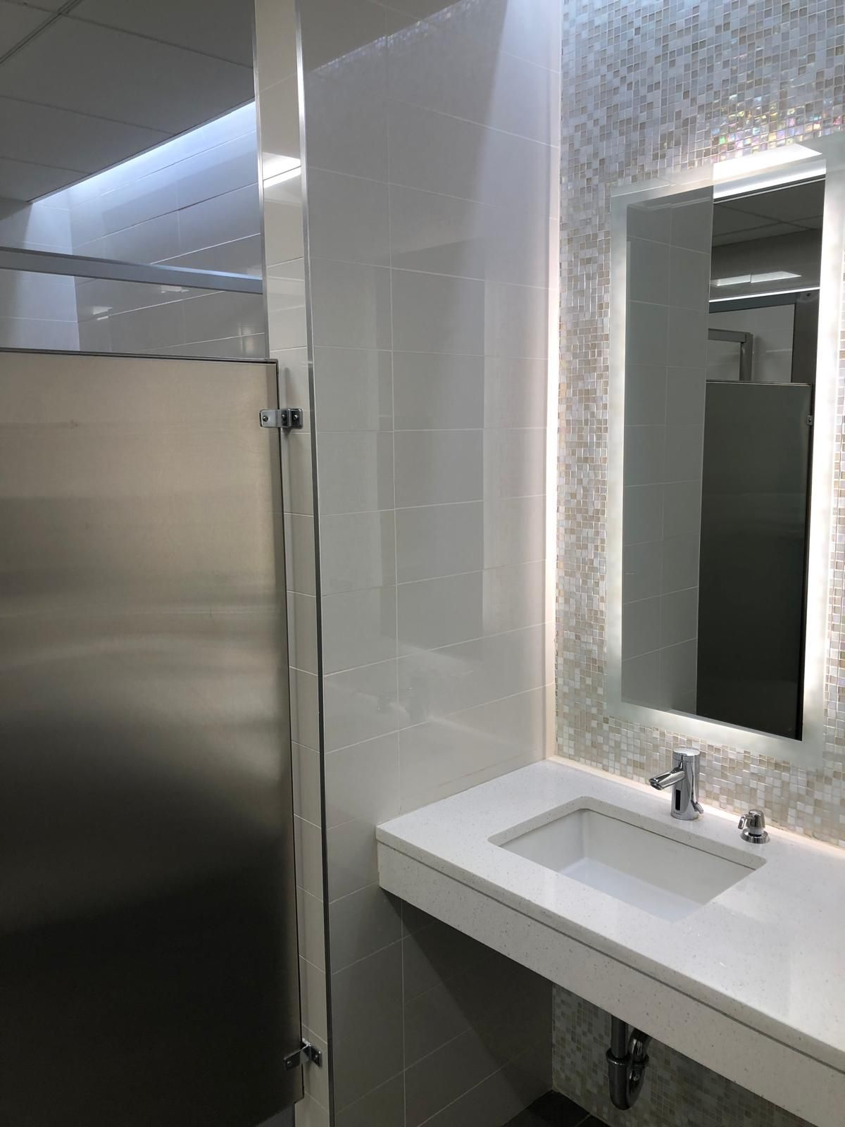 A bathroom with a sink and a mirror.