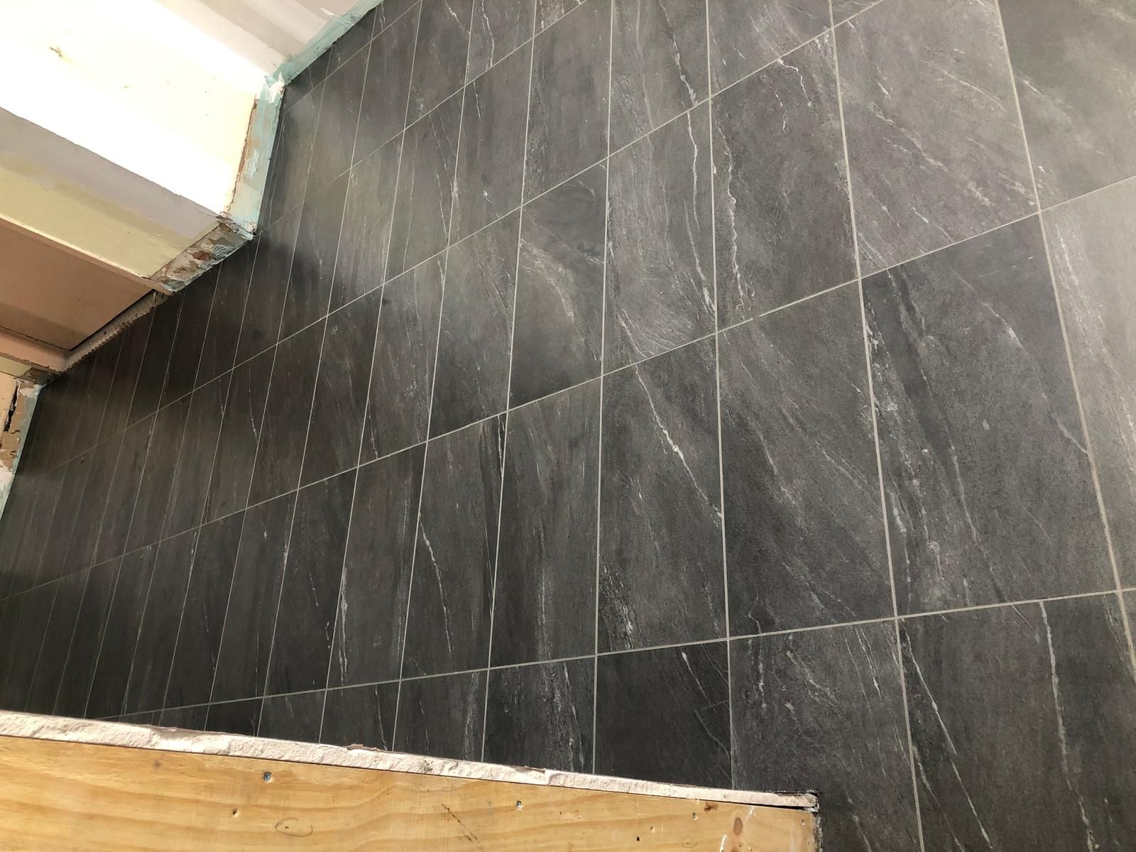 A close up of a black tile floor in a room.