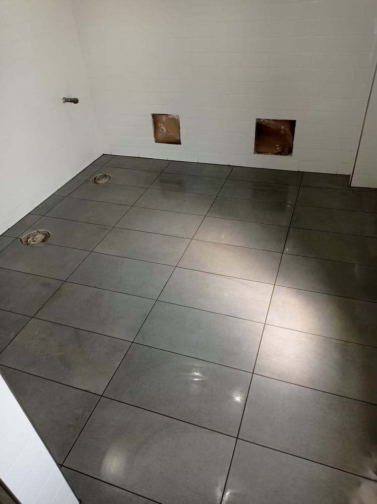 A room with a tiled floor and white walls