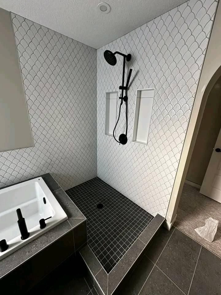 A bathroom with a walk in shower and a bathtub.