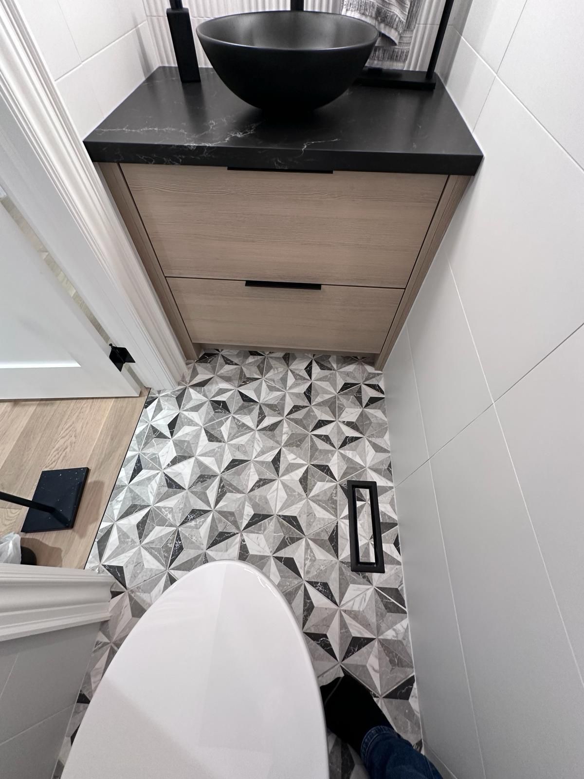 A toilet is sitting in a bathroom next to a sink.