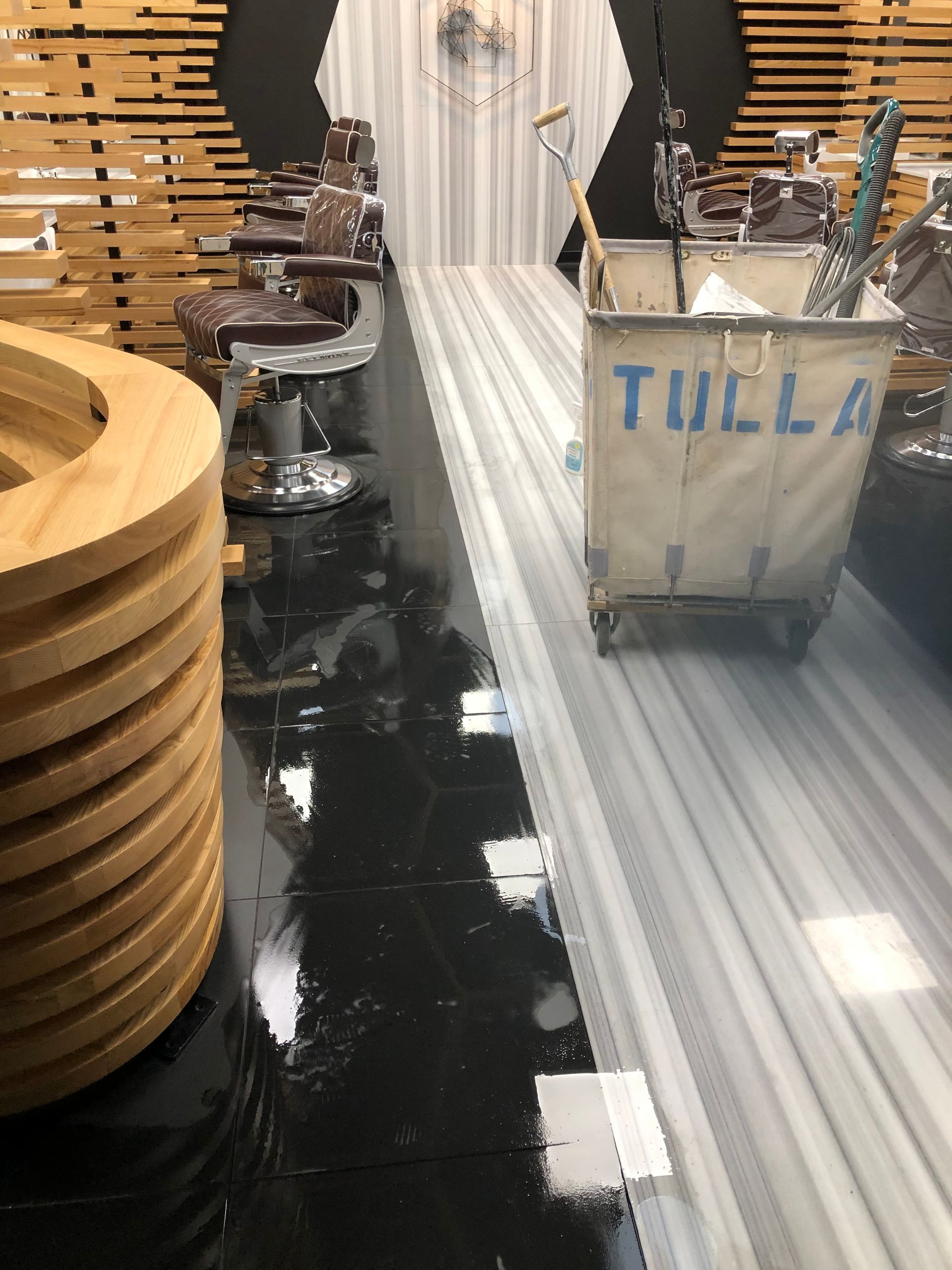 A barber shop with a cart that says tulla on it