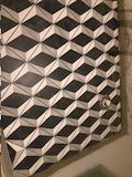 A black and white geometric pattern on a wall.