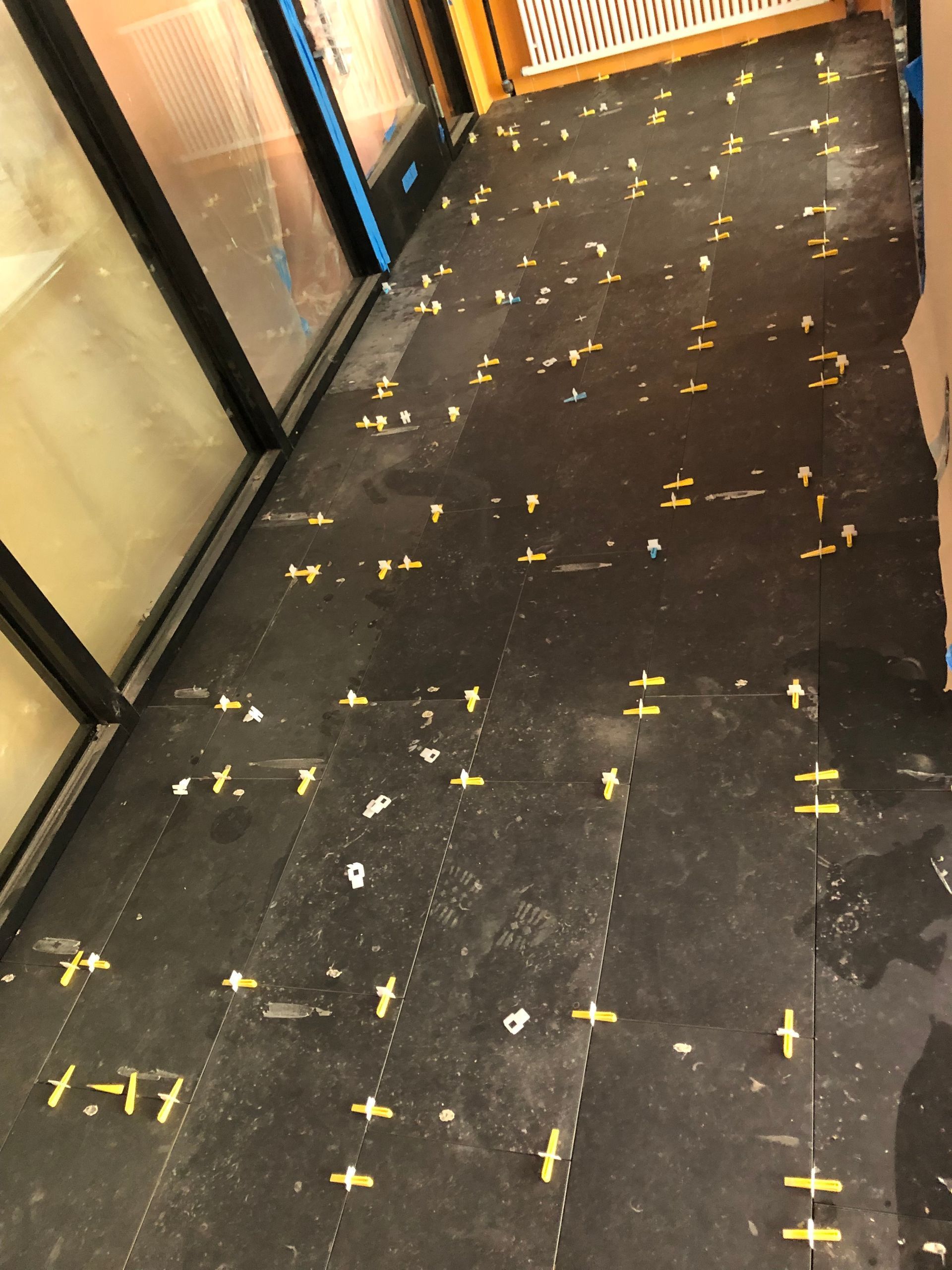 A black floor with a lot of yellow crosses on it