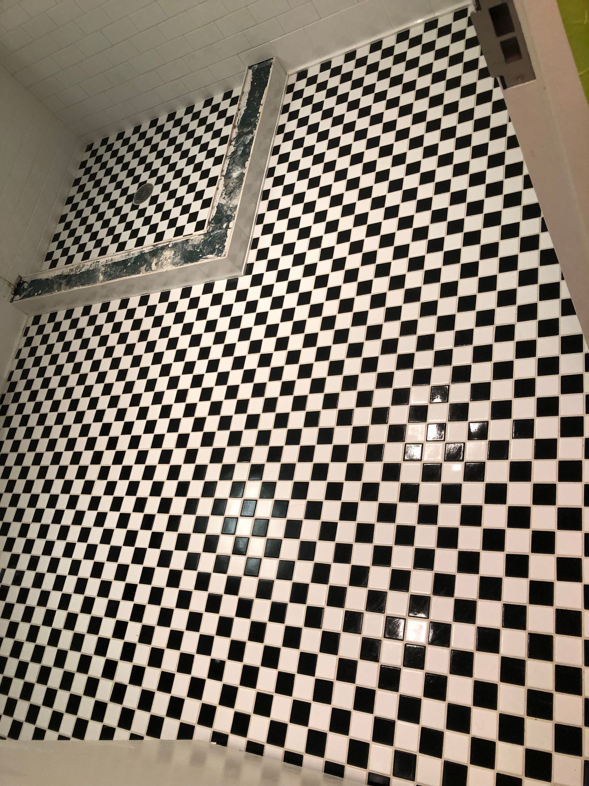 A black and white checkered tile floor in a bathroom.