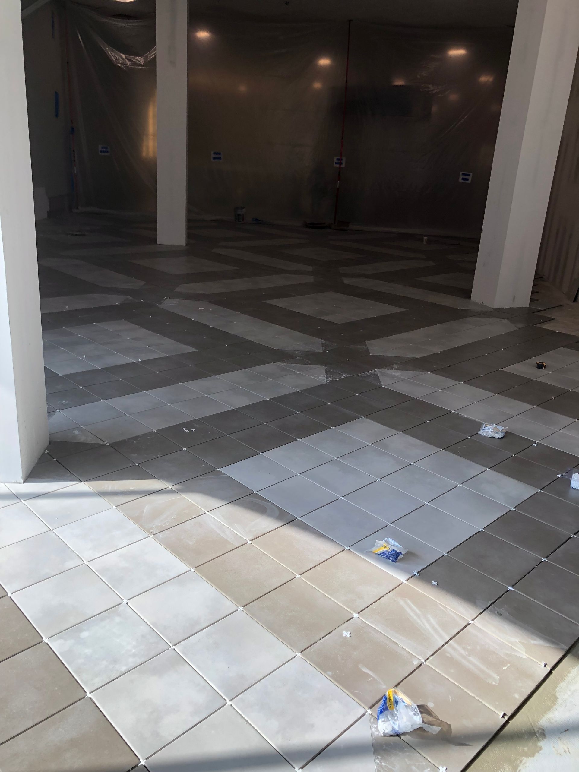 A large empty room with a checkered tile floor.