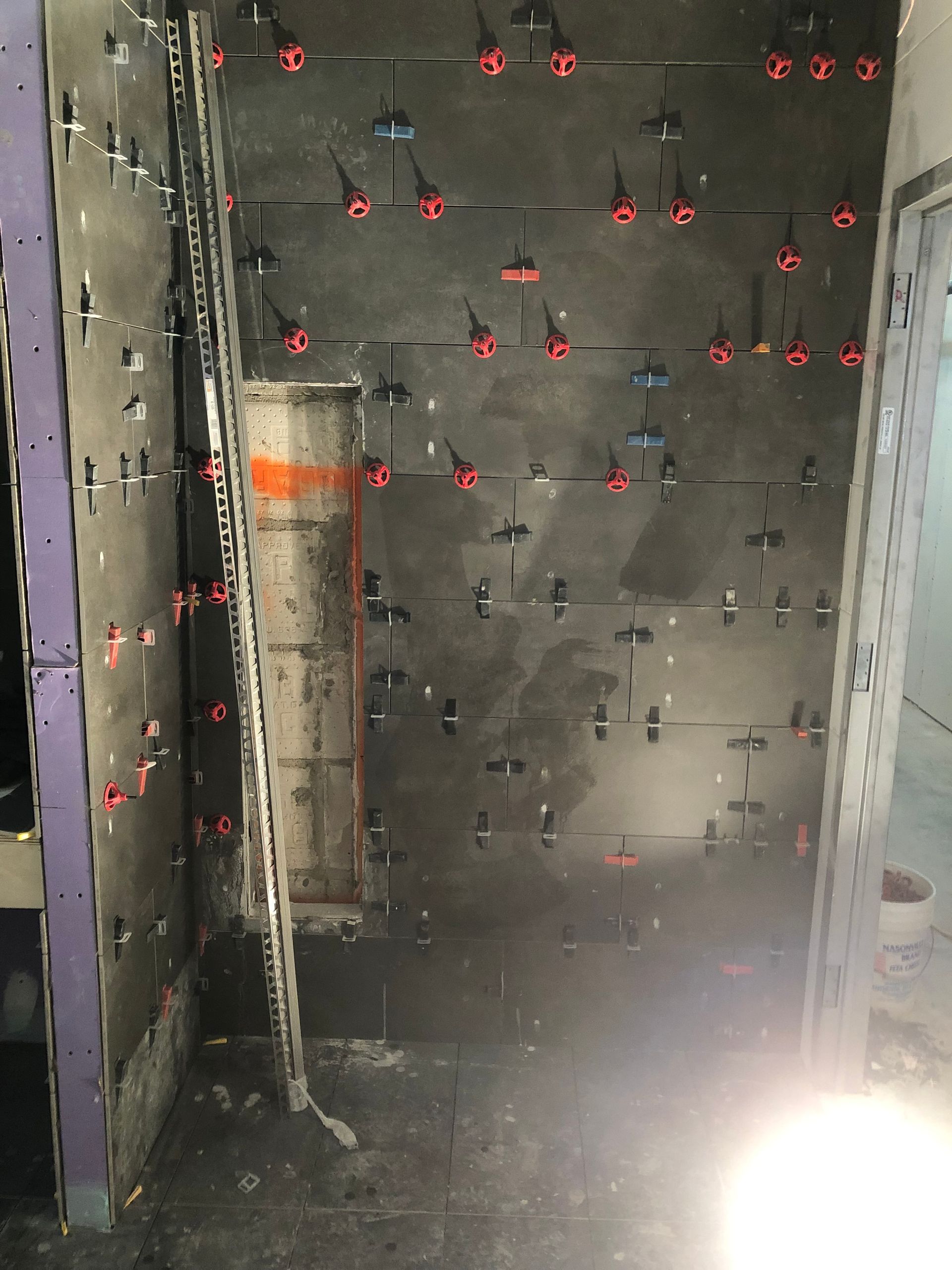 A room with a lot of screws on the wall