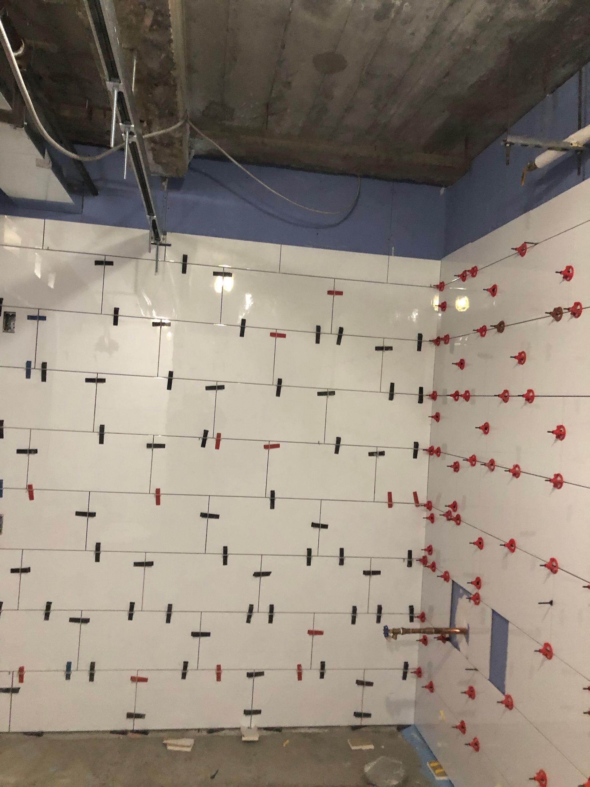 A room with a lot of tiles on the wall