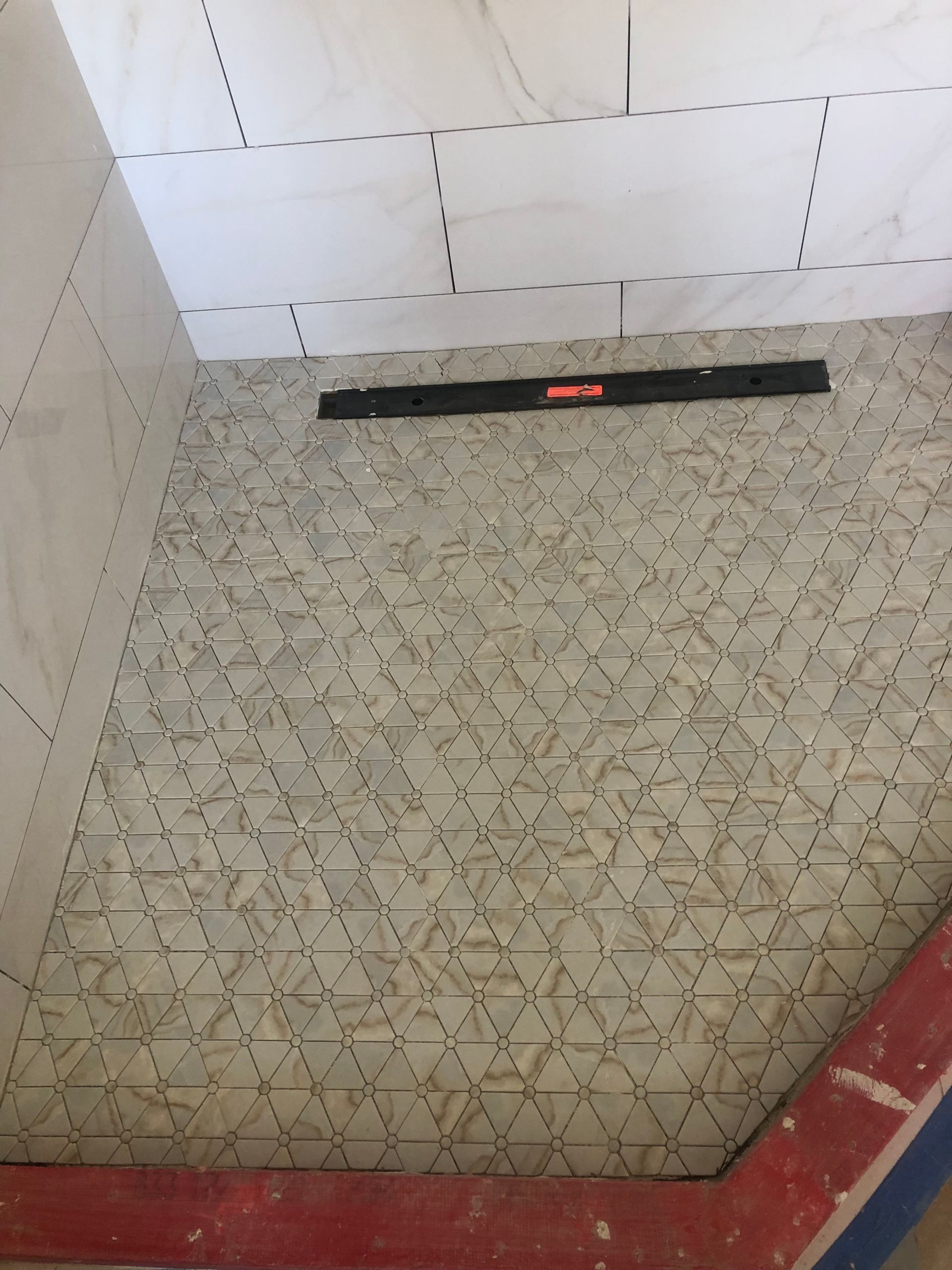 A tiled floor with a black level on it
