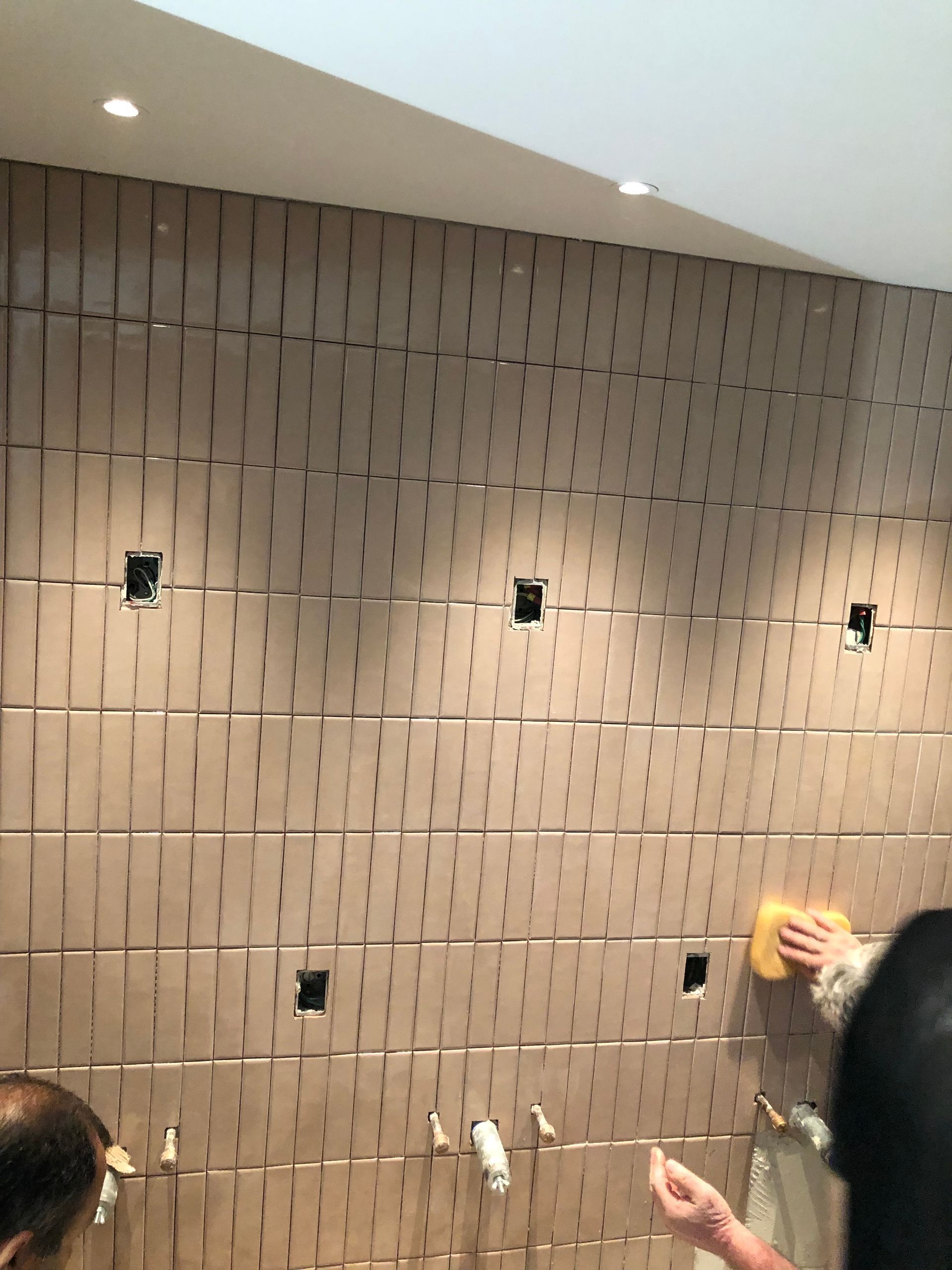 A person is cleaning a wall with holes in it