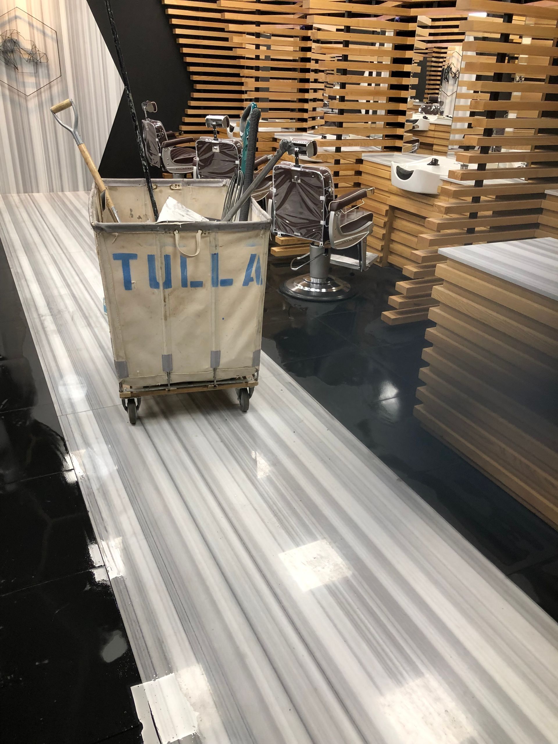 A barber shop with a cart that says tulla on it
