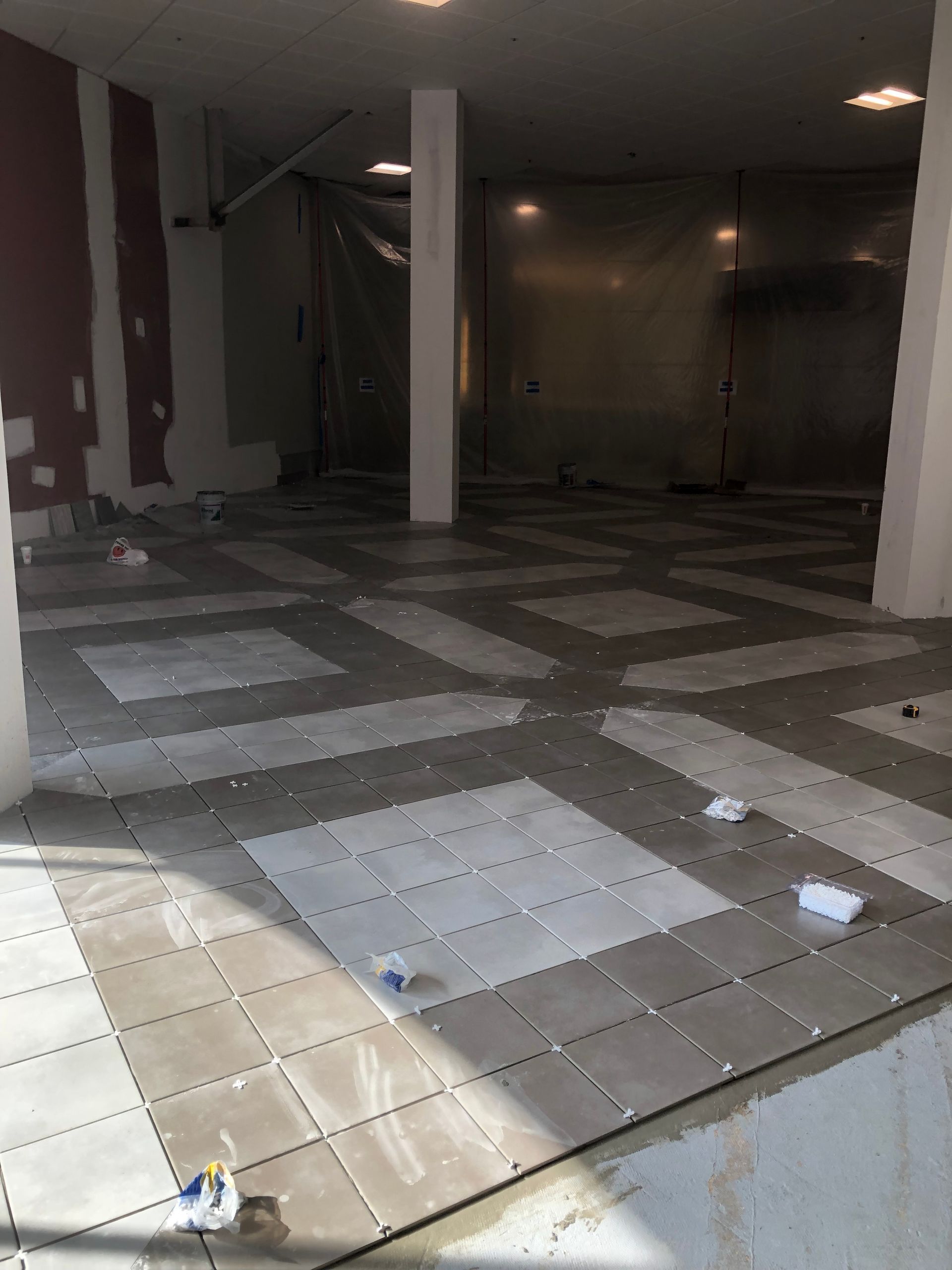 A large empty room with tiles on the floor