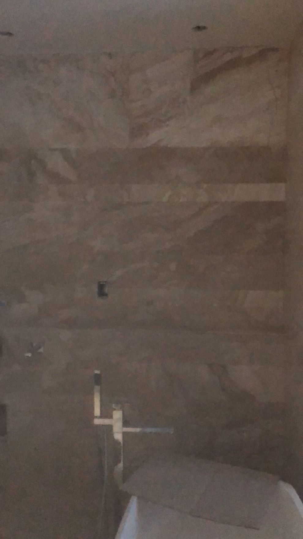 A bathroom with a toilet , sink and shower.