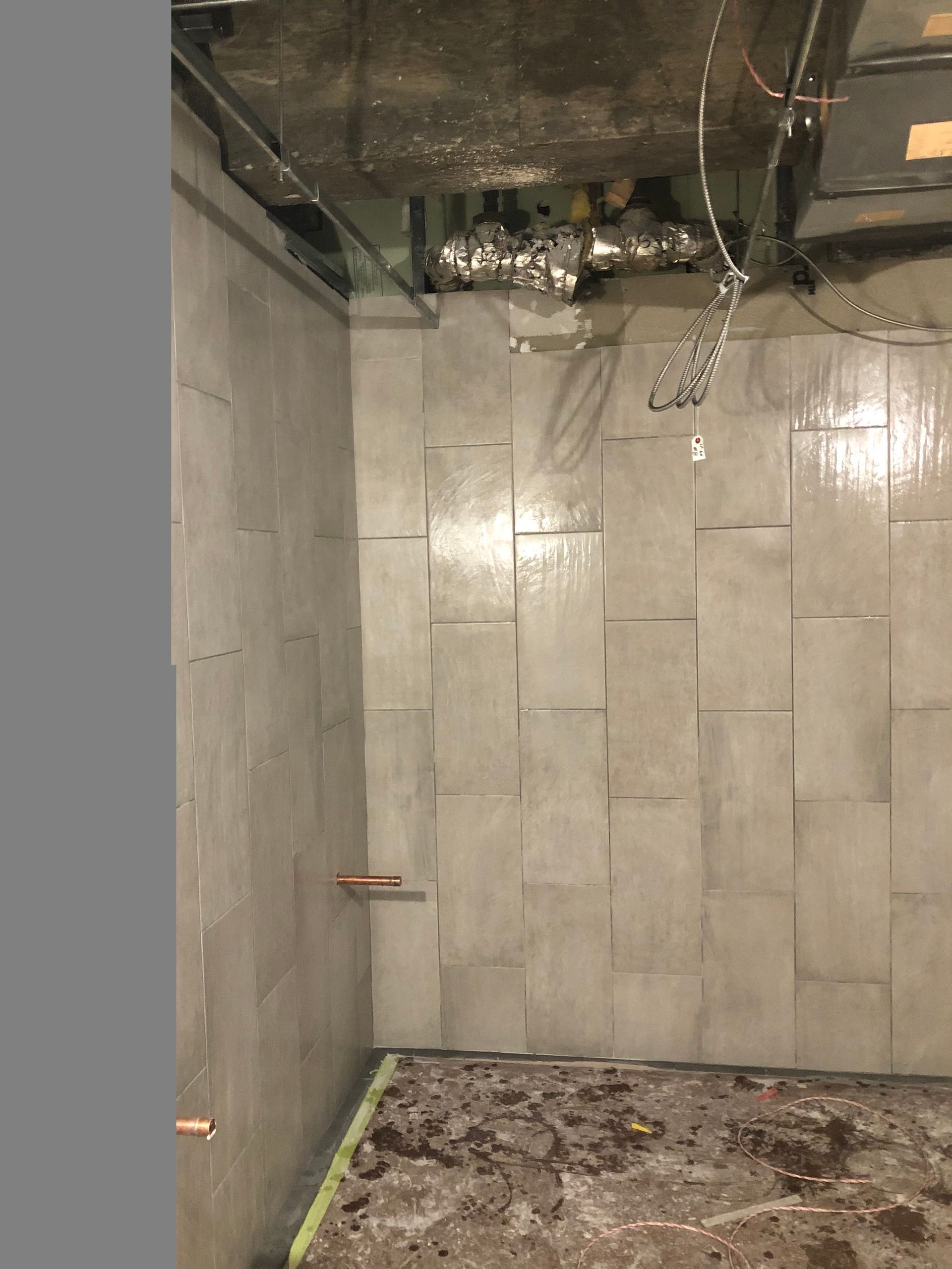 A room with a lot of tiles on the wall and a ceiling.