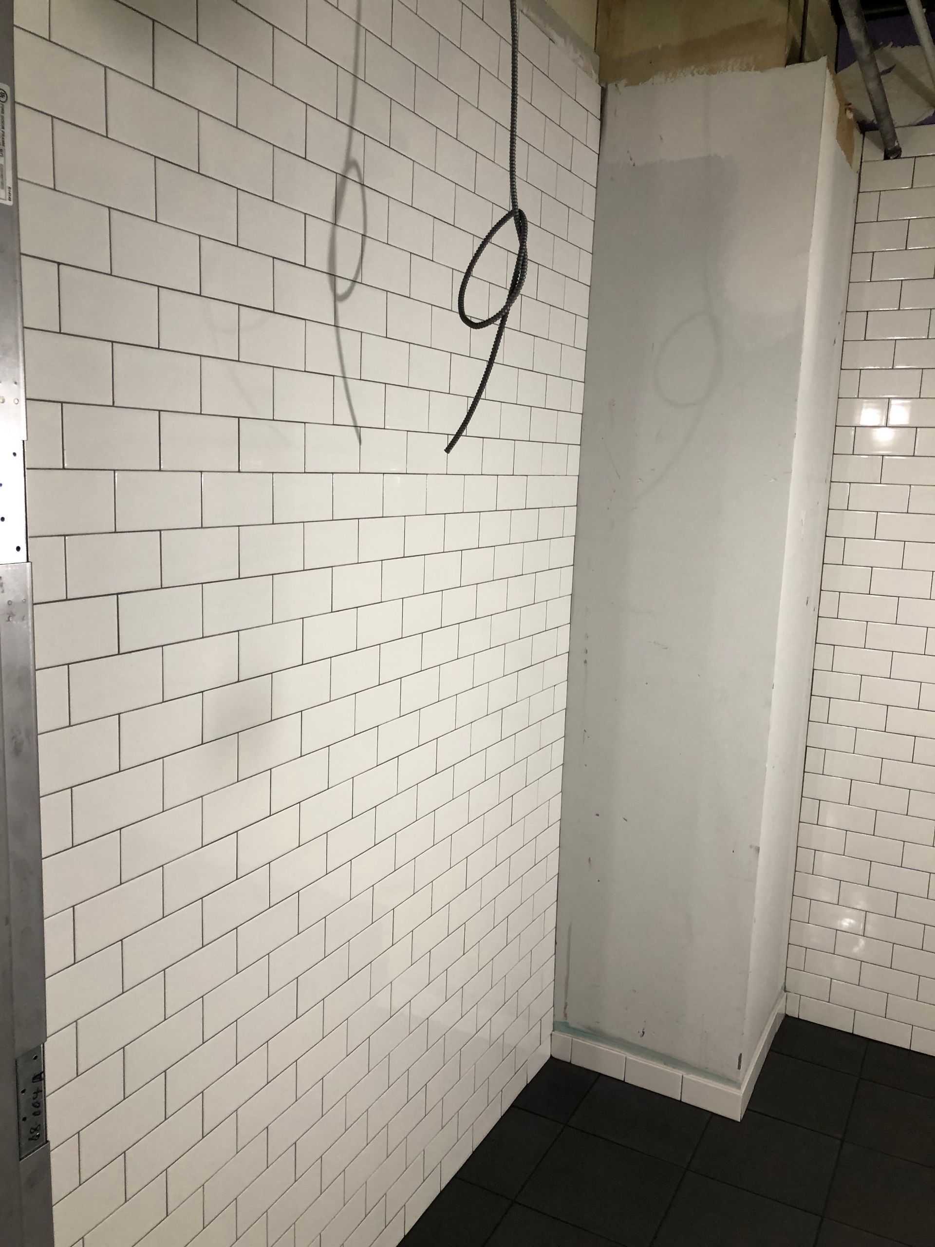 A white brick wall with the number 9 on it