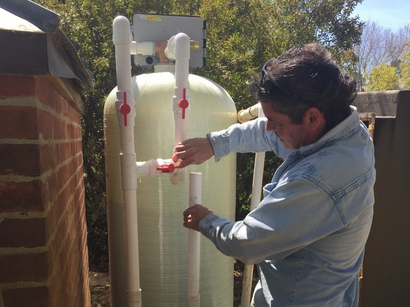 Man Repairing the System of Water Filtration — Mira, LA — Advanced Water Treatment LLC