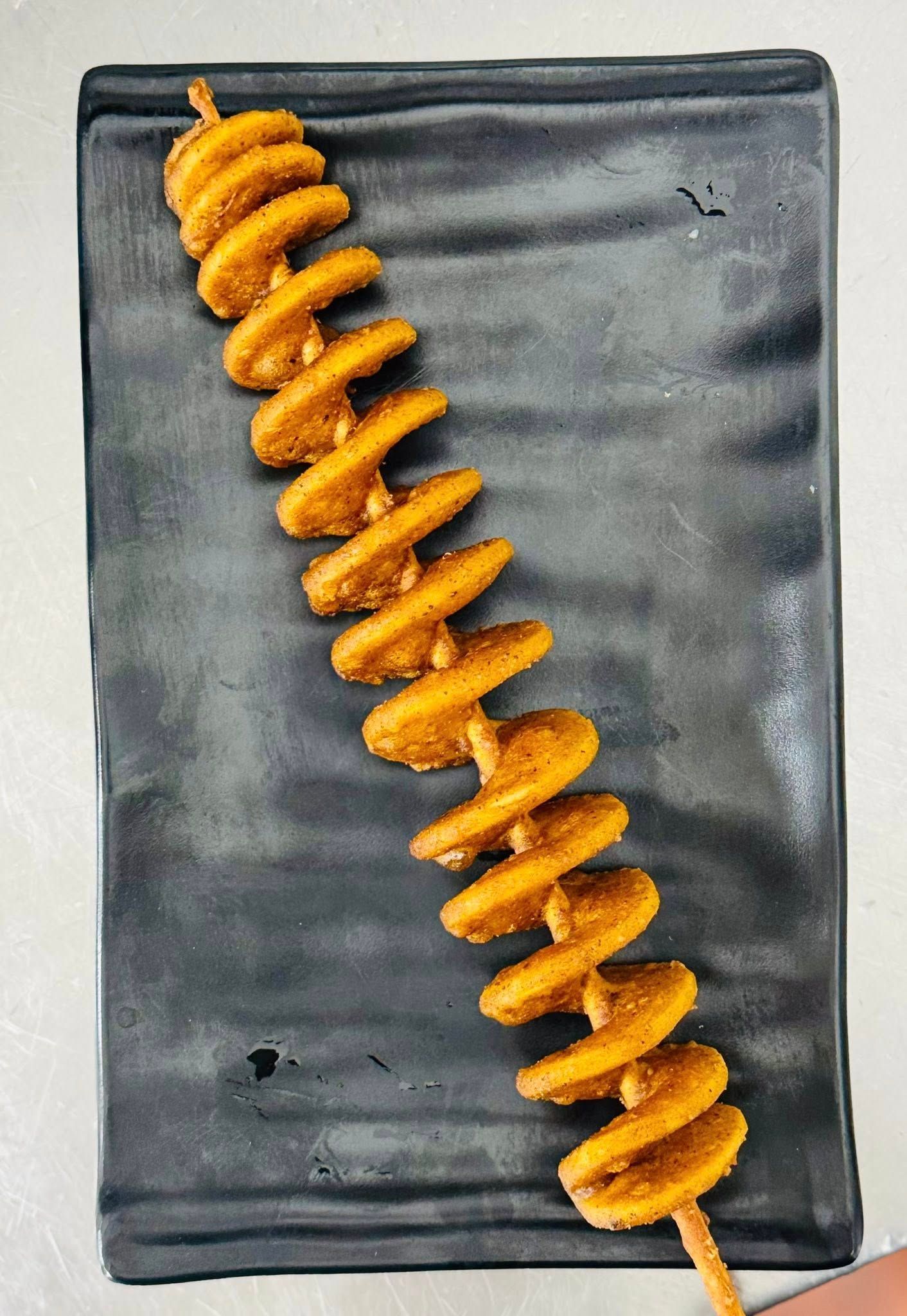 Spiral-cut Fried Potato on a Wooden Skewer — Pt Cartwright Seafoods in Warana, QLD