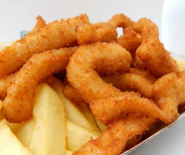 Fried Calamari and French Fries in a White Paper Container — Pt Cartwright Seafoods in Warana, QLD