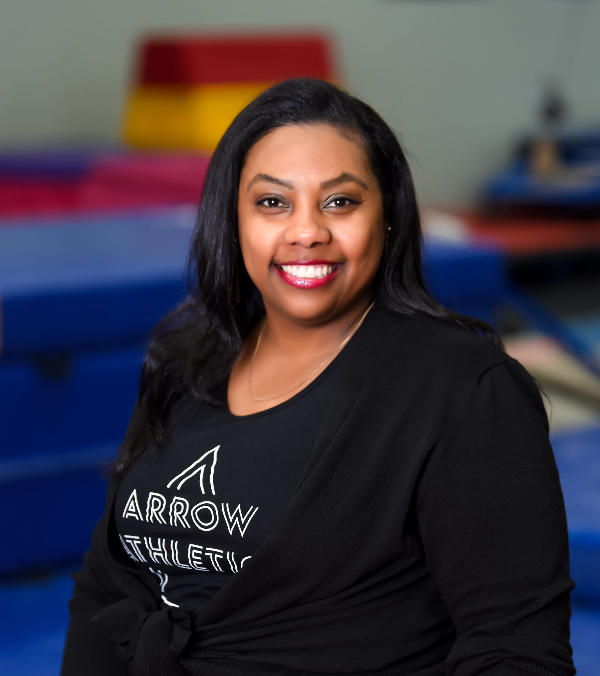 A woman wearing a black shirt with the word arrow on it