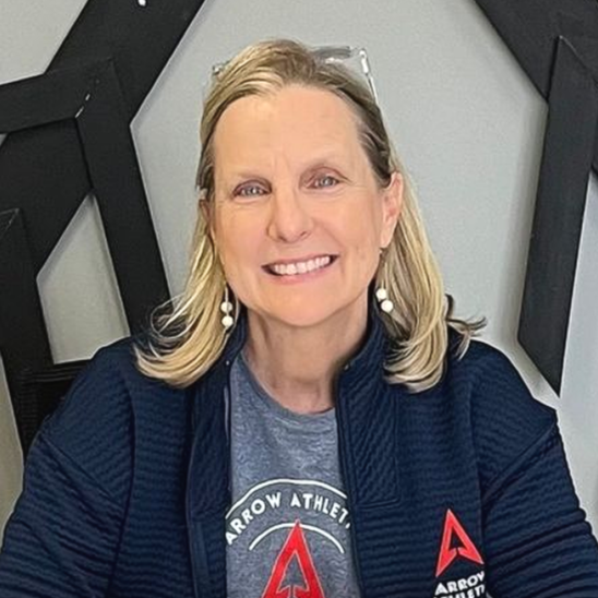 A woman wearing a black shirt with the word arrow on it