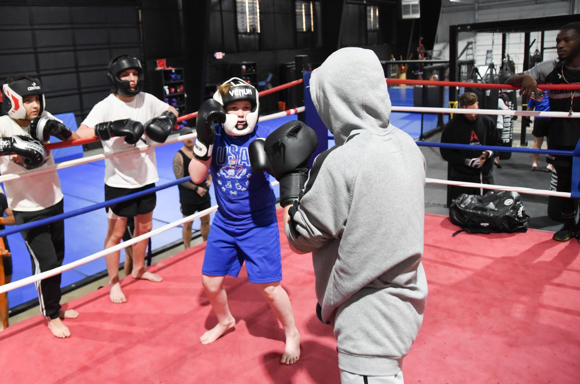 A group of people are boxing in a boxing ring.