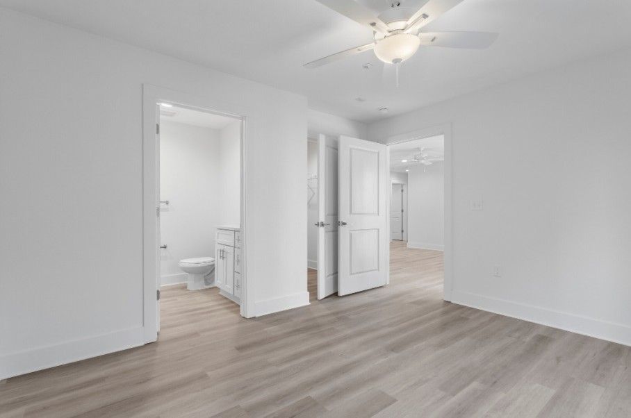 primary bedroom in 1 bedroom apartment floorplan in Biloxi MS with wood floors, bathroom, and walk in closet