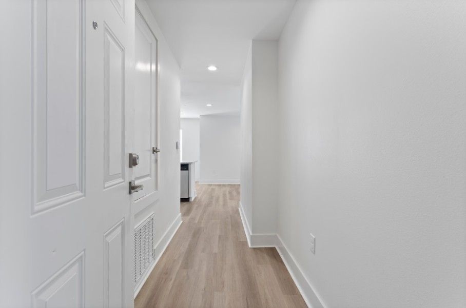 Big entryway to apartment in Biloxi with wood floors and opening up to living room and kitchen