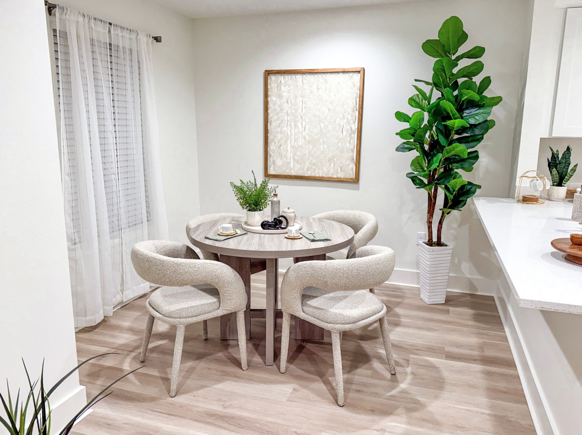 dining room set in apartment complex in Biloxi with large plants and natural decor