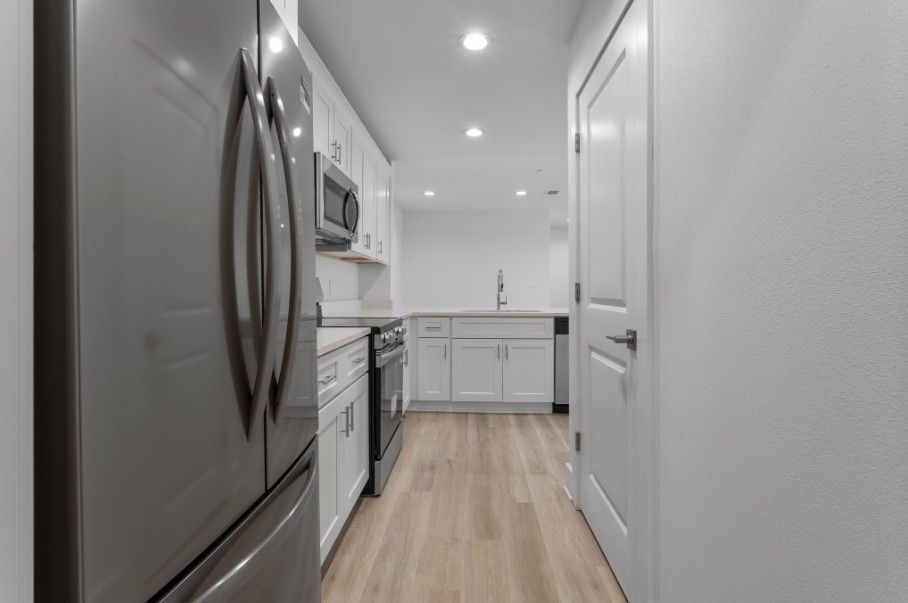 apartment kitchen in Biloxi with stainless steel appliances and wood flooring