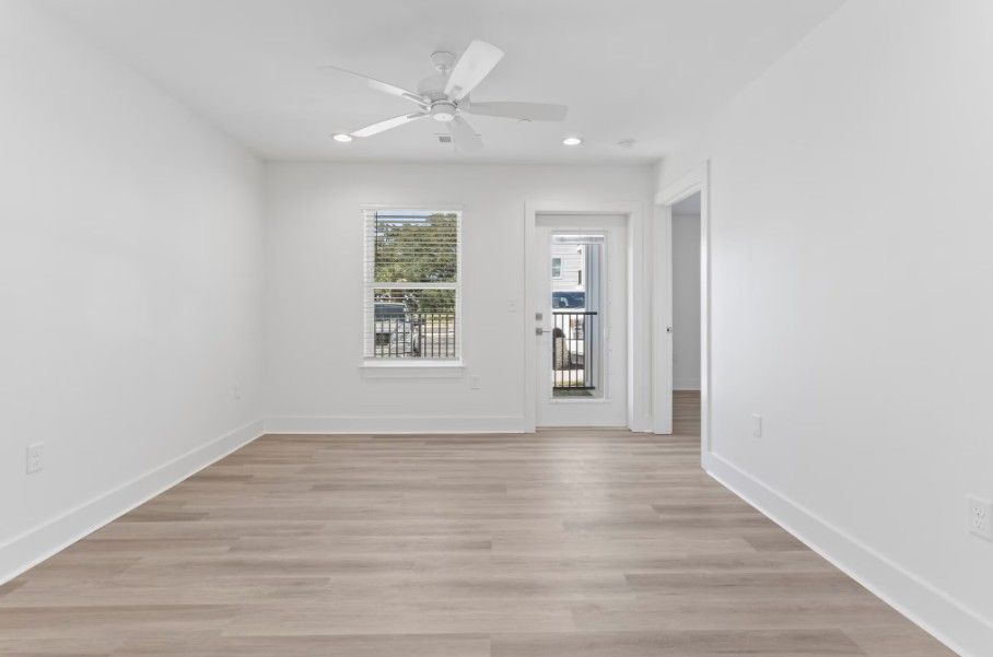 Large living room in Biloxi apartment with wood floors and outside lounge area